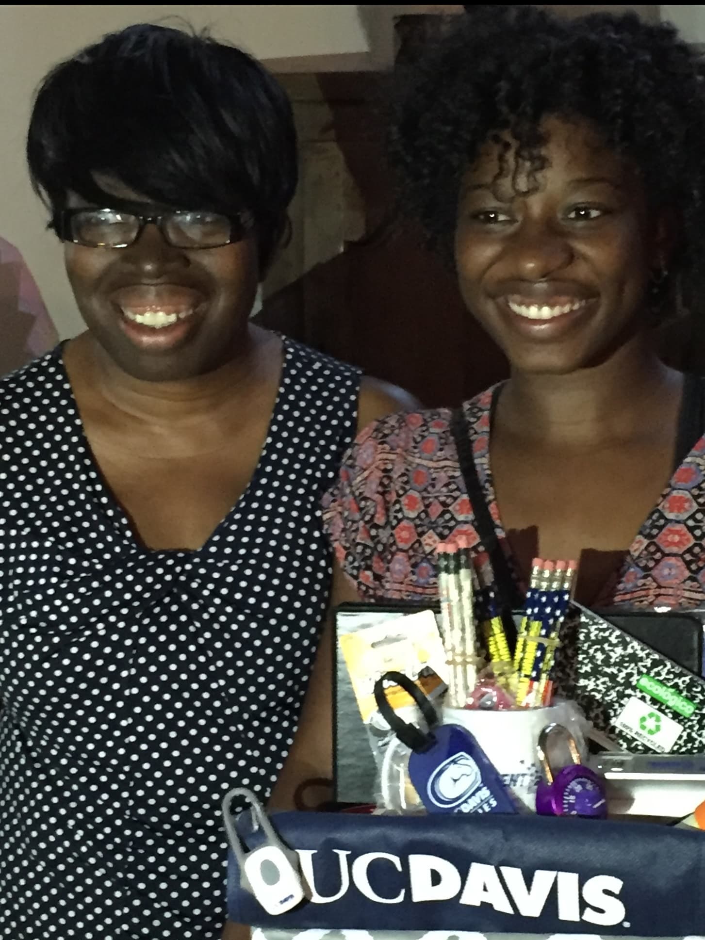 Kelsey and Mom smiling with a UC Davis gift basket