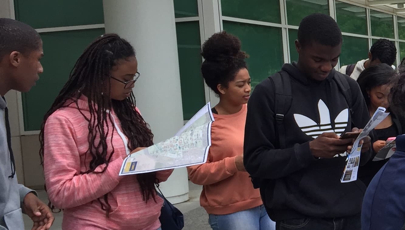 WHD scholars reading a campus map together on an Xploration Tour
